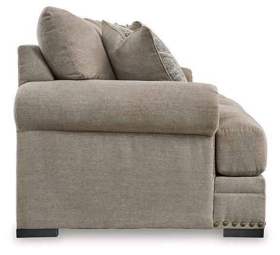 Ashley Furniture Galemore sofa showing plush gray fabric, wide armrests, and cushioned back for comfortable seating.