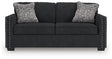 Ashley Furniture Jasmine Peaks sofa with plush cushions and neutral fabric, shown from a head-on view.