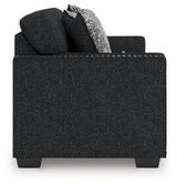 Ashley Furniture Jasmine Peaks sofa with plush cushions and fabric upholstery, shown from the side.