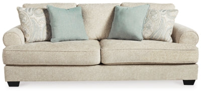 Ashley Furniture Monaghan sofa with plush cushions and neutral fabric, shown from a head-on angle.