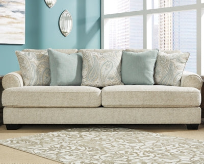 Ashley Furniture Monaghan Sofa with plush cushions and neutral fabric, shown in a cozy living room setting.