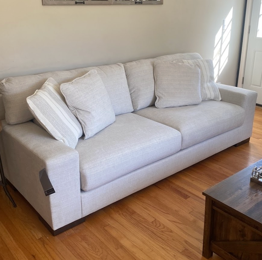 Ashley Furniture Newport Sofa with plush upholstery and modern design, shown in a cozy living room setting.