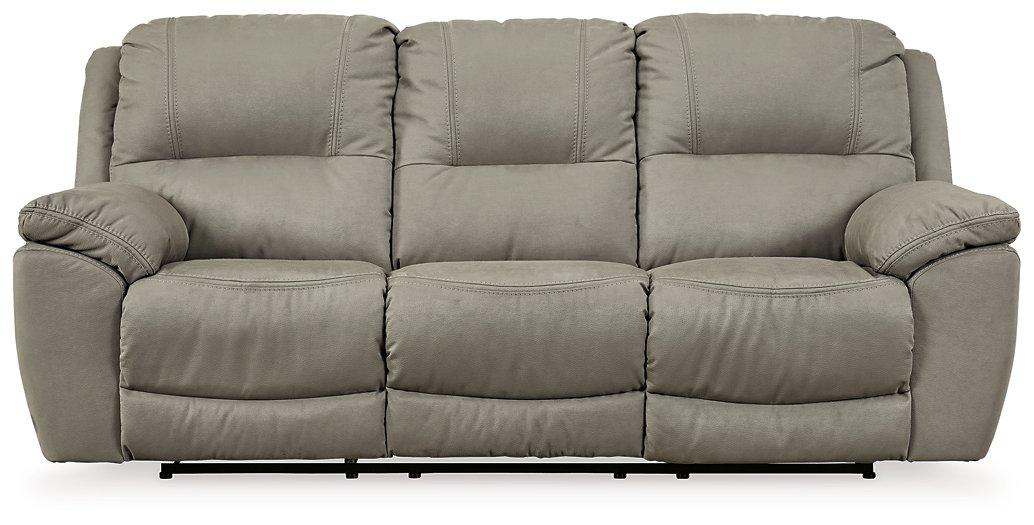 Ashley Furniture Next-Gen Gaucho Reclining Sofa showing plush fabric, padded armrests, and reclining sections in a modern living room setting.