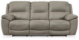 Ashley Furniture Next-Gen Gaucho Reclining Sofa showing plush fabric, padded armrests, and reclining sections in a modern living room setting.