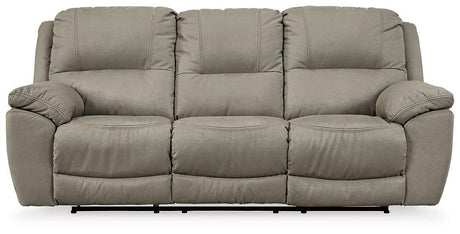 Ashley Furniture Next-Gen Gaucho Reclining Sofa showing plush fabric, padded armrests, and reclining sections in a modern living room setting.