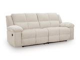 Ashley Furniture Orlen reclining sofa shown from an angle, featuring plush cushions and a modern design in a cozy living room setting.