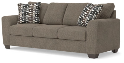 Ashley Furniture Triston-Peaks sofa in a stylish angled view, featuring plush cushions and a contemporary design.