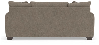 Ashley Furniture Triston-Peaks sofa with plush cushions and wooden legs, shown from the back view.