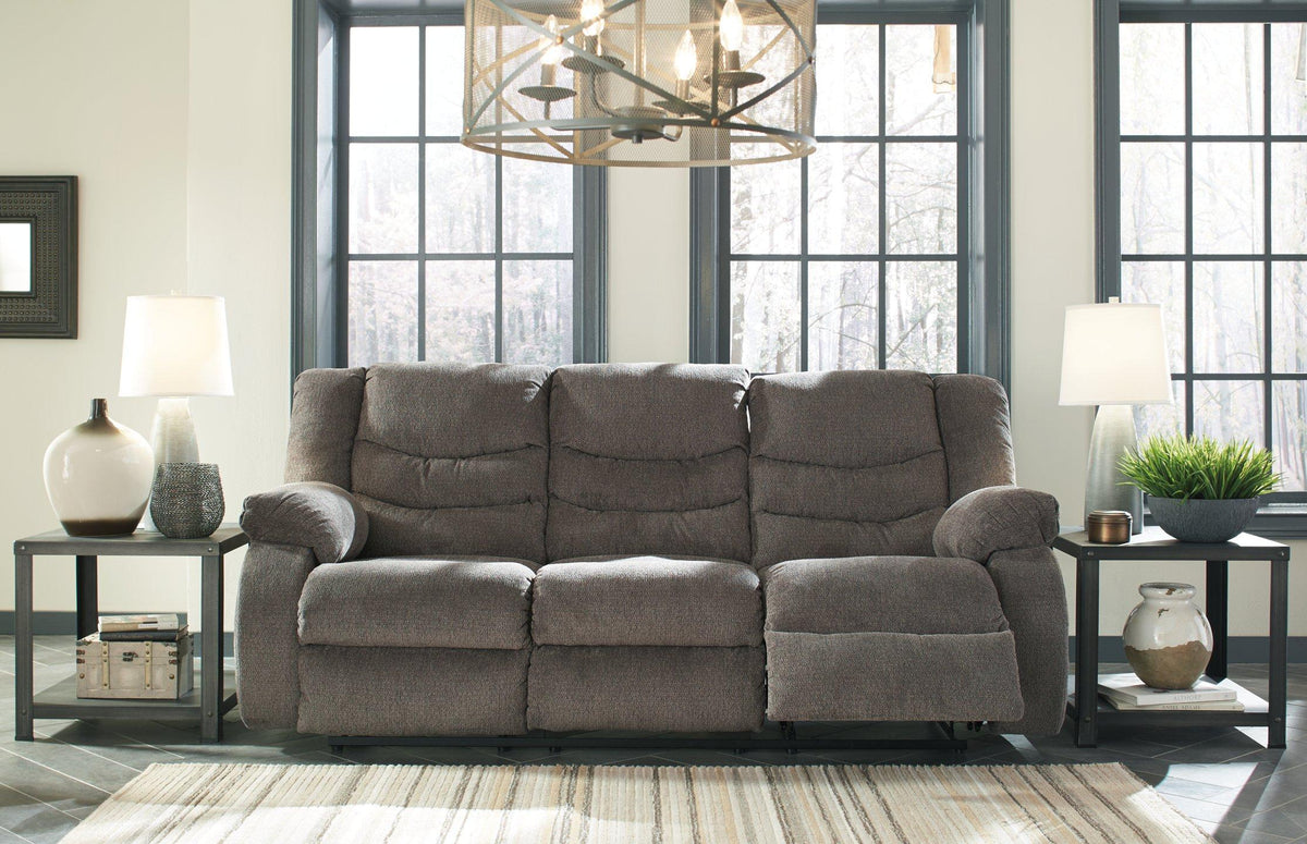 Ashley Furniture Tulen reclining sofa with plush cushions and modern design, shown in a comfortable, relaxed seating position.
