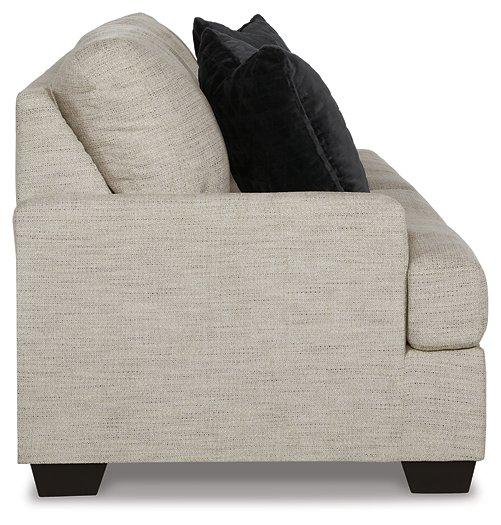 Ashley Furniture Vayda Sofa with plush cushions and modern design, shown in a cozy living room setting.
