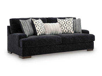 Ashley Furniture Whitmore Manor sofa shown from an angle, featuring plush upholstery and classic design details.