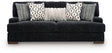 Ashley Furniture Whitmore Manor sofa with plush beige upholstery and tufted back, shown from a front head-on view.