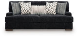 Ashley Furniture Whitmore Manor sofa with plush beige upholstery and tufted back, shown from a front head-on view.