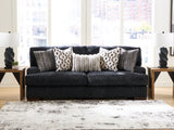 Ashley Furniture Whitmore Manor sofa featuring plush fabric, cushioned arms, and elegant design, perfect for living room decor.
