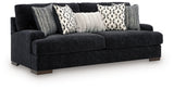 Ashley Furniture Whitmore Manor sofa shown from an angled side view, featuring plush upholstery and elegant design.