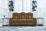 Ashley Furniture Wolfridge power reclining sofa with plush fabric and padded armrests, featuring multiple reclining sections for comfort.