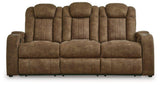 Wolfridge Power Reclining Sofa by Ashley Furniture showing plush fabric, reclining mechanism, and cushioned armrests in a modern living room setting.