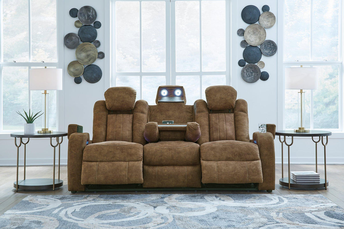 Ashley Furniture Wolfridge power reclining sofa with plush cushions and dark upholstery, showcasing comfortable seating and reclining features.