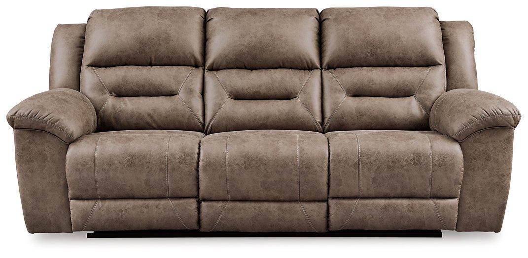 Ashley Furniture Stoneland Power Reclining Sofa with plush cushions and reclining features, shown in a modern living room setting.