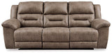 Ashley Furniture Stoneland Power Reclining Sofa with plush cushions and reclining features, shown in a modern living room setting.