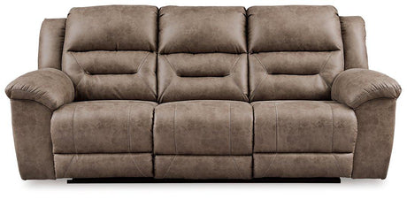 Ashley Furniture Stoneland Power Reclining Sofa with plush cushions and reclining features, shown in a modern living room setting.