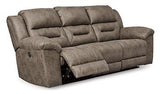 Ashley Furniture Stoneland Power Reclining Sofa with plush cushions and modern design, shown in a cozy living room setting.