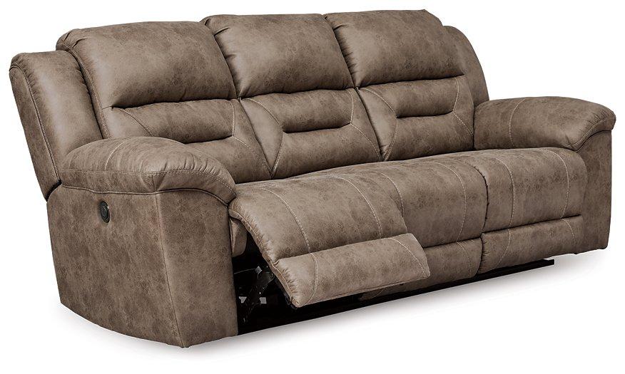 Ashley Furniture Stoneland Power Reclining Sofa with plush cushions and dark leather upholstery, designed for comfort.