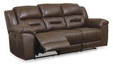 Ashley Furniture Stoneland Power Reclining Sofa with plush cushions and reclining mechanisms, shown in a modern living room setting.