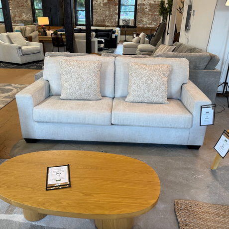 Ashley Furniture Camden Sofa with plush cushions and modern design, shown in a cozy living room setting.