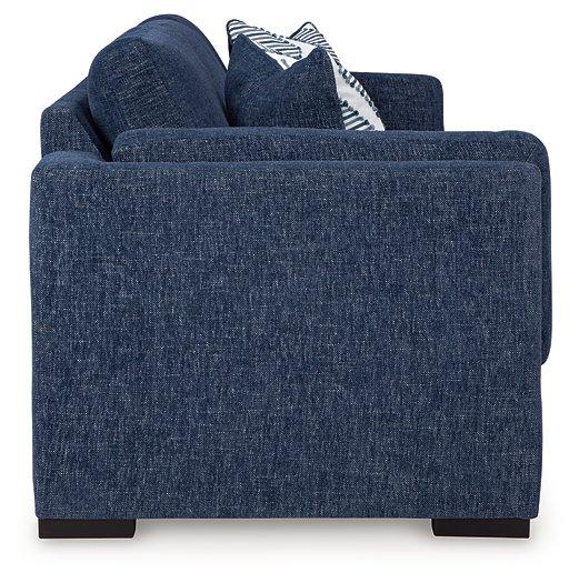 Ashley Furniture Evansley Sofa with plush fabric and modern design, featuring wide armrests and comfortable cushioning.
