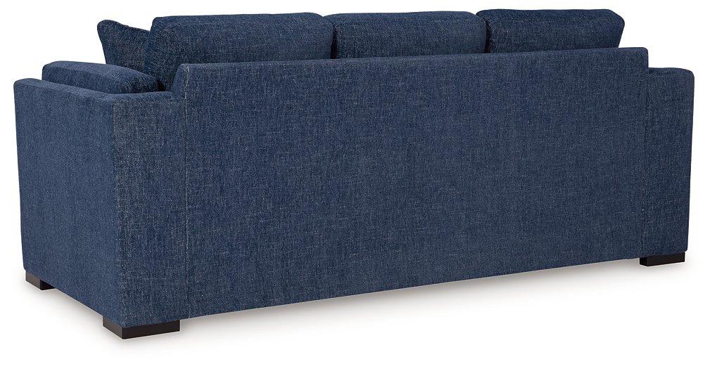 Ashley Furniture Evansley Sofa, plush upholstered sofa with rolled arms and wooden legs, in a neutral fabric.