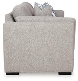 Ashley Furniture Evansley sofa in a neutral fabric with plush cushions and wide armrests, shown in a modern living room setting.
