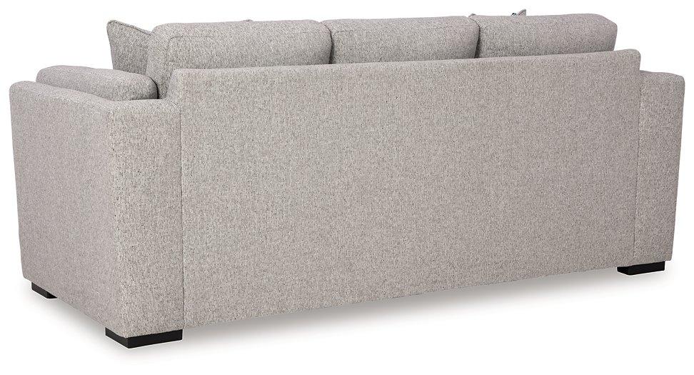 Ashley Furniture Evansley Sofa with plush fabric and wide armrests, shown in a modern living room setting.