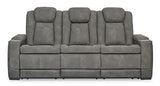Next-Gen DuraPella Power Reclining Sofa by Ashley Furniture, showing plush cushioned seats and recliner mechanisms in a modern living room setting.
