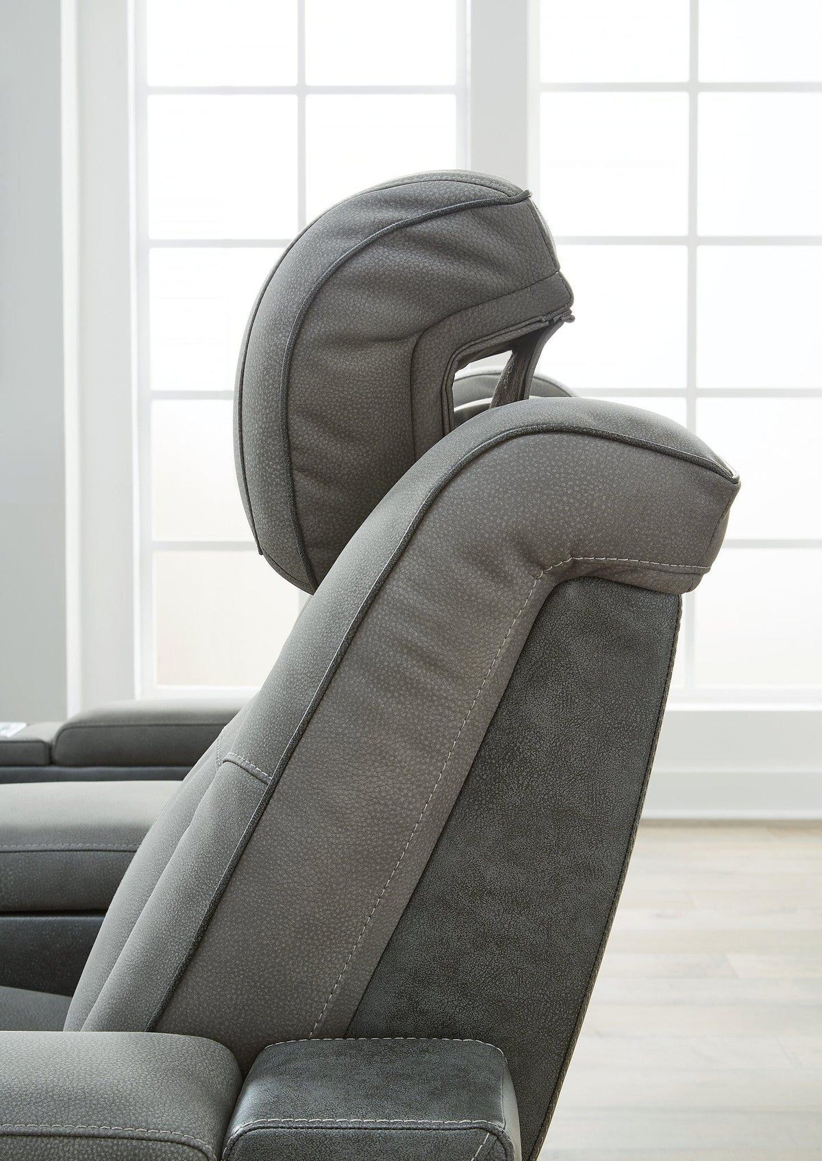 Next-Gen DuraPella Power Reclining Sofa by Ashley Furniture, showing plush gray fabric, padded armrests, and reclining seats.