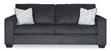 Ashley Furniture Altari Sofa with plush cushions and modern design, shown in a cozy living room setting.