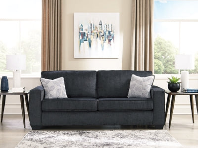 Ashley Furniture Altari sofa with plush fabric and modern design, featuring wide armrests and neutral color upholstery.
