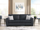 Ashley Furniture Altari sofa with plush fabric and modern design, featuring wide armrests and neutral color upholstery.