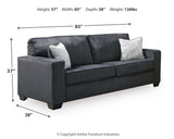 Ashley Furniture Altari sofa with plush fabric, wide armrests, and stylish design in a cozy living room setting.