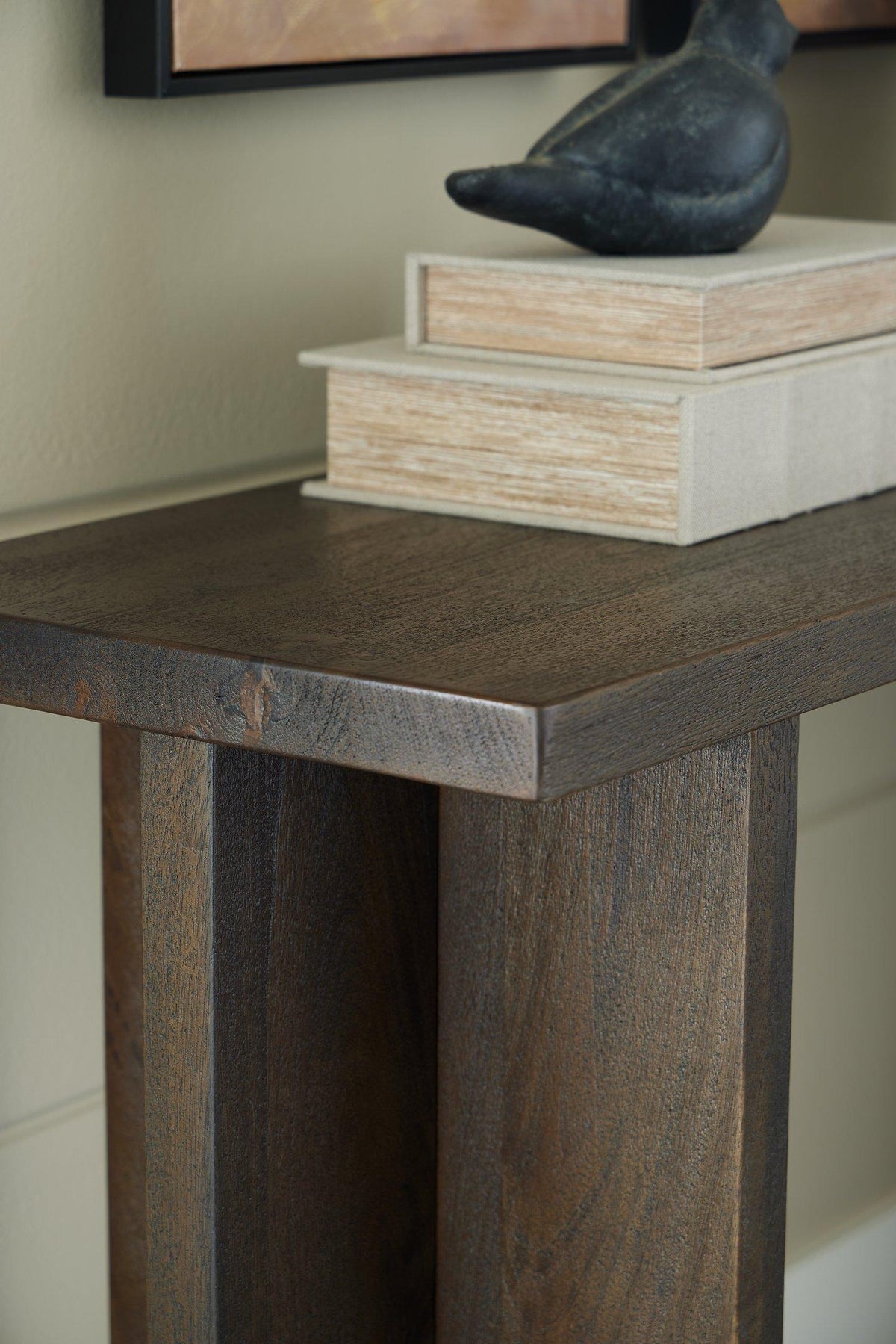 Ashley Furniture Jalenry Console Sofa Table with sleek wooden surface and modern design, ideal for living room decor.