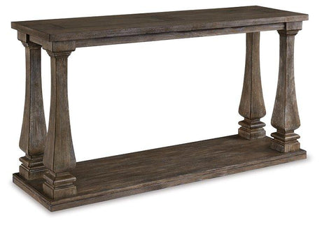 Ashley Furniture Johnelle sofa table with wood finish, featuring a modern design and ample surface space for living room decor.
