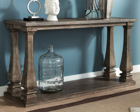 Ashley Furniture Johnelle sofa table with a sleek wooden finish and modern design, perfect for living room decor.
