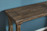 Ashley Furniture Johnelle sofa table with a sleek wooden finish, featuring a spacious tabletop and stylish design for living room decor.