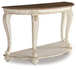 Ashley Furniture Realyn sofa table with wood finish and metal accents, featuring a modern design for living room decor.