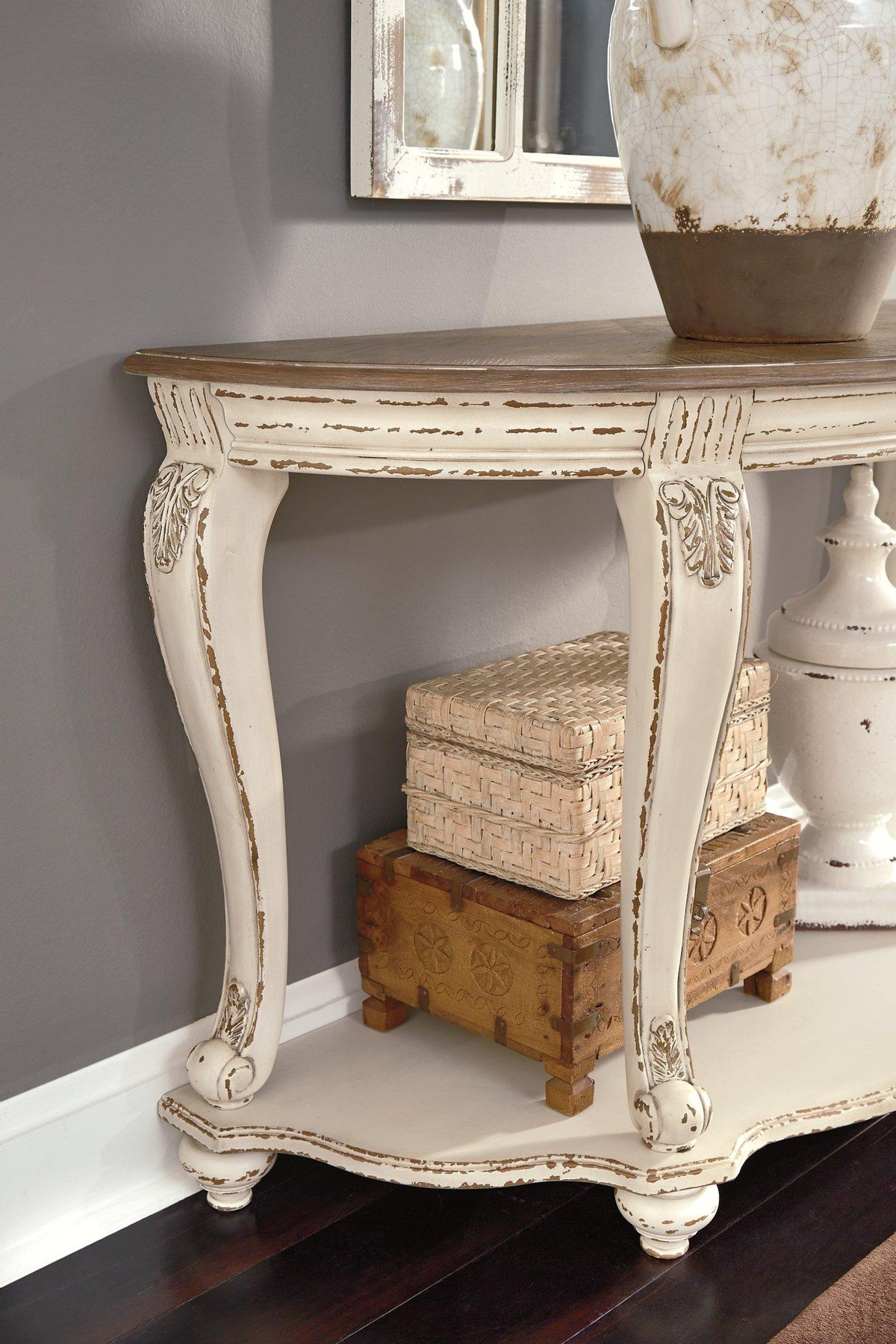 Ashley Furniture Realyn sofa table with a sleek wooden surface and modern design, ideal for living room decor.