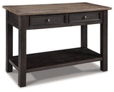 Ashley Furniture Tyler Creek sofa table showing a wooden console with a smooth finish and storage drawers.