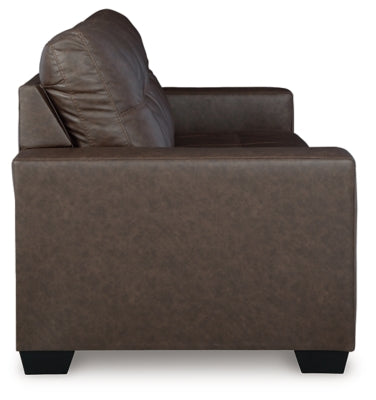 Ashley Furniture Barlin Mills sofa with beige fabric and plush cushions, shown from a side angle in a living room setting.