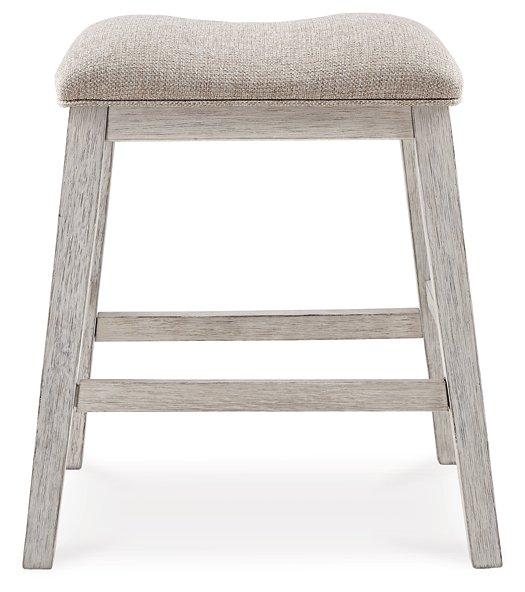 Ashley Furniture Skempton counter height bar stool with wooden legs and cushioned seat, ideal for kitchen or bar area.