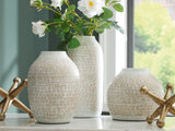 Ashley Furniture Vinburn table accessory set with five stylish decorative pieces arranged on a wooden surface.