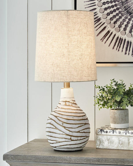 Aleela table lamp by Ashley Furniture featuring a sleek design with a fabric shade and modern base, ideal for living room decor.